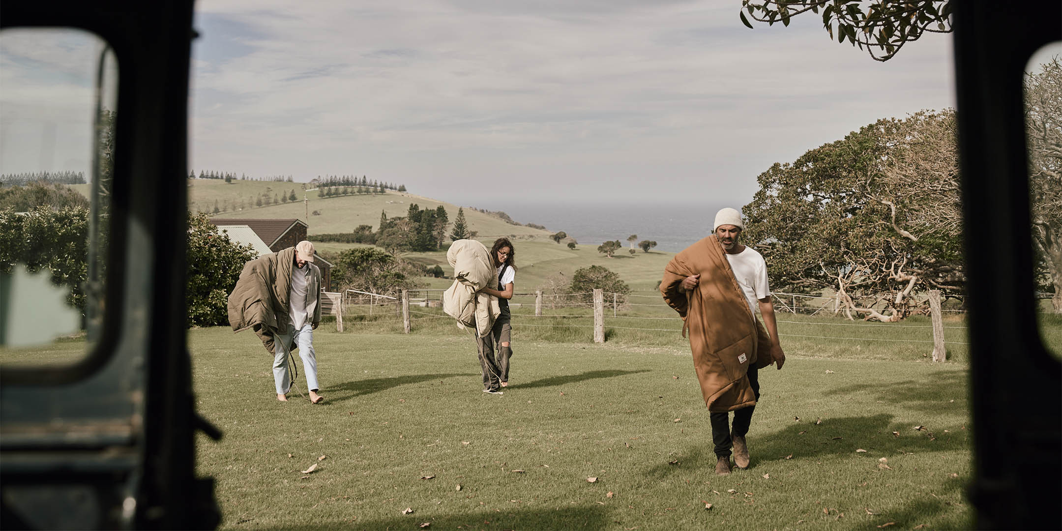 girl and guy at either end of a van in the australian bush